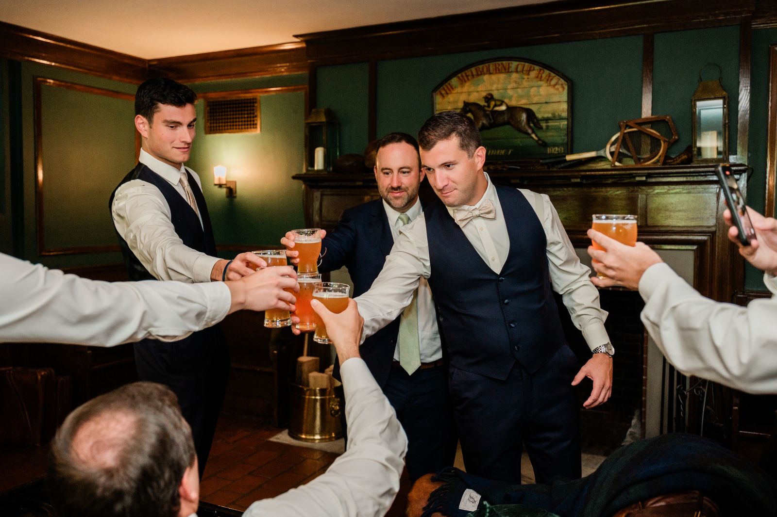 A groom and his groomsmen toast before a wedding ceremony at Lord Thompson Manor in Connecticut